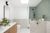 The kids' bathroom has a decidedly more youthful feel, with terazzo flooring and vanities and mirrors from West Elm.