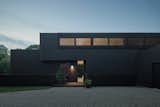 After entering through a gate, the home's charred spruce siding presents a somber face.