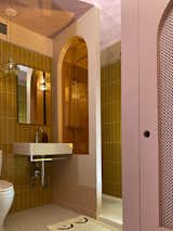 Stacked tiles from Spanish company Porcelanosa line the wall behind the sink and in the shower. Antonio bought the Peill & Putzler Wave pendants when he lived in Germany.