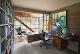 The home office offers a sunny atrium-like area with stairs leading up to additional workspace.