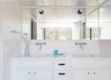A mirror directly across from the en suite’s massive window serves to double the view.