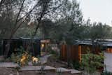 Pine and gravel sleepers follow the site’s natural slope, weaving through the existing pine trees until reaching the home’s entrance.