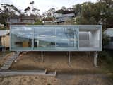 The cabin hovers over the site on stilts, giving it a floating effect.